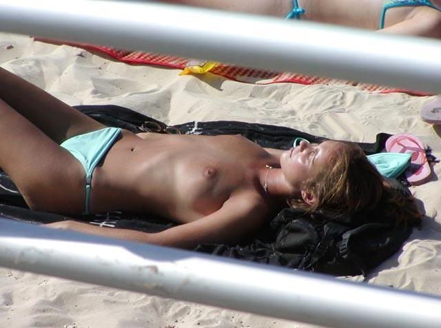 15P Watch this sexy blonde teen lay in the water naked