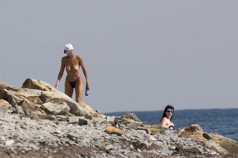 15P Bouncy breasted nudist girl strips and bares all