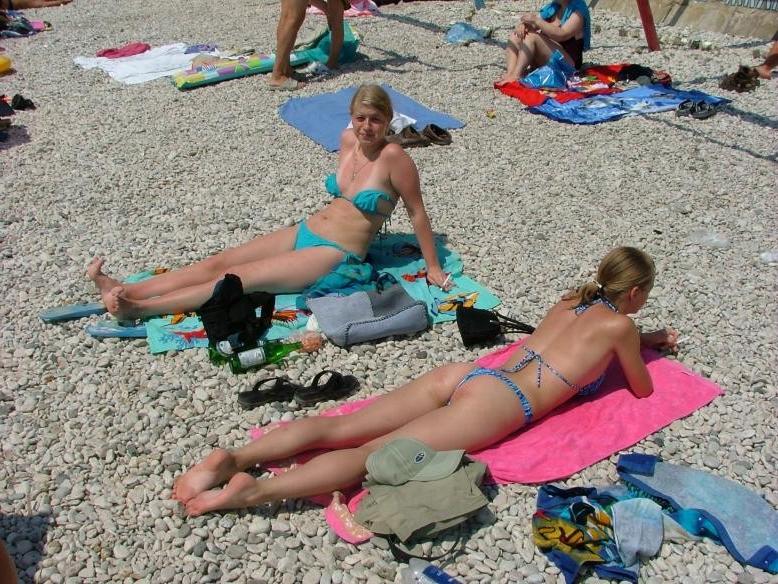15P Hot Russian nudist strips her bikini off here