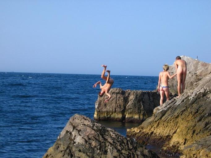 15P Wild naked chick has a great time at a nude beach