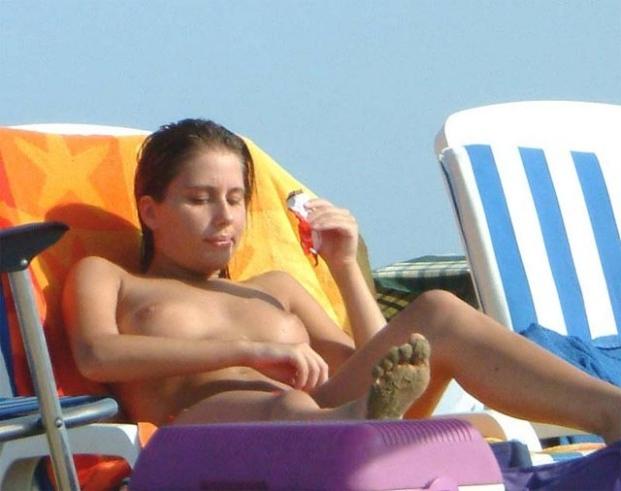 15P Watch this sexy blonde babe lay in the water naked
