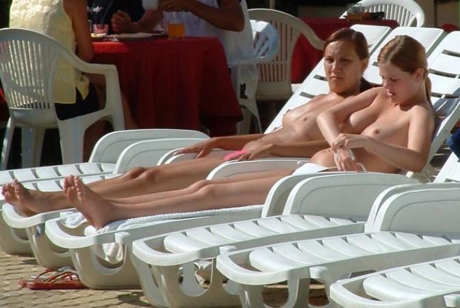 15P Wild naked chick has a great time at a nude beach