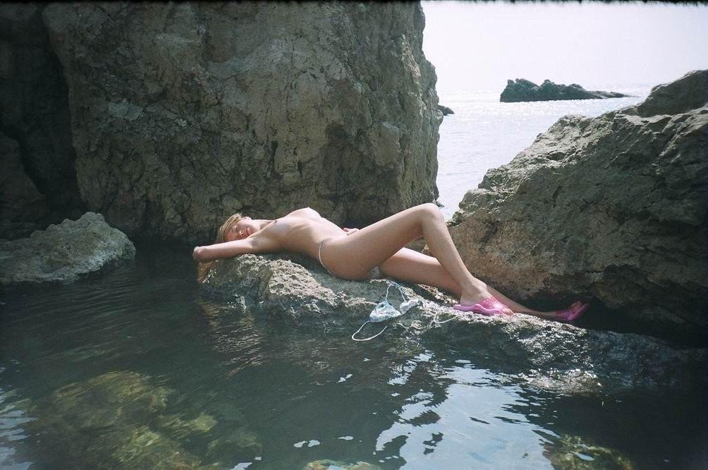 15P Wild naked chick has a great time at a nude beach
