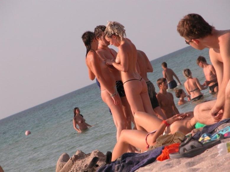 15P Wild naked chick has a great time at a nude beach