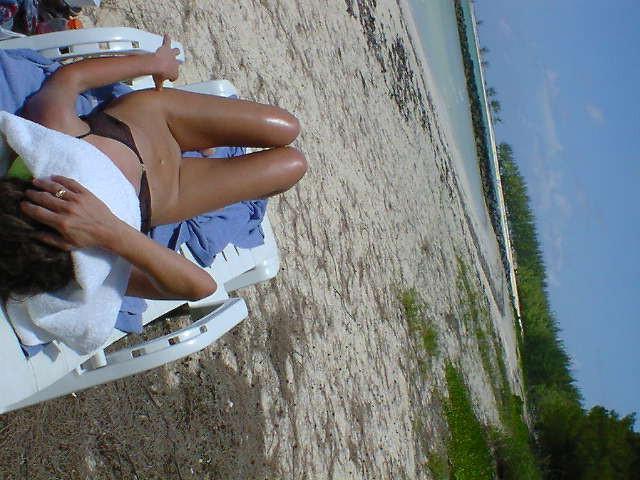 15P Watch a naked chick at the beach tan her hot body