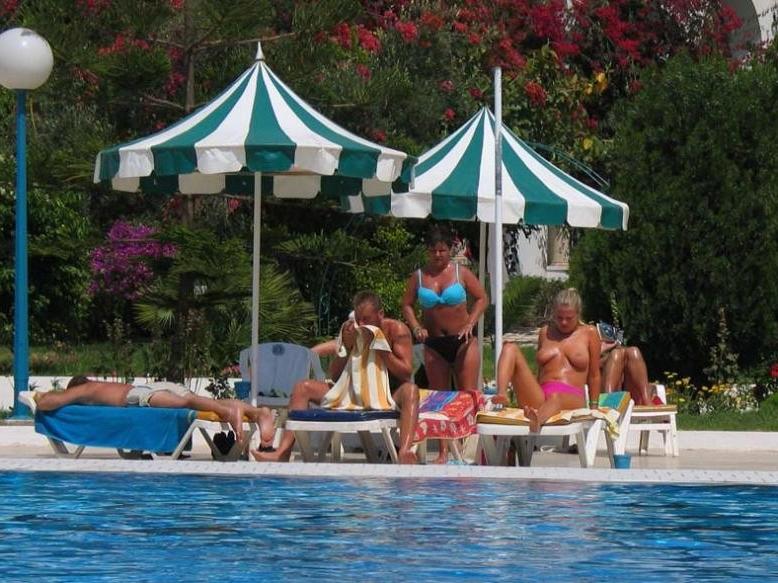 15P The water feels good on these nudist's bare skin