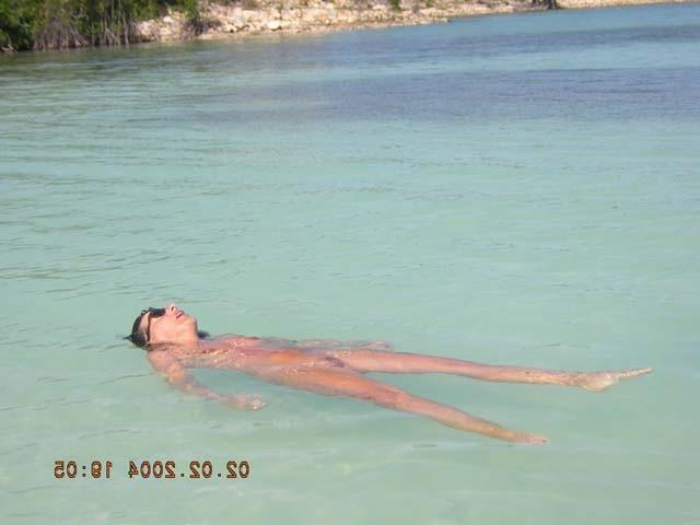 15P Watch this sexy blonde babe lay in the water naked