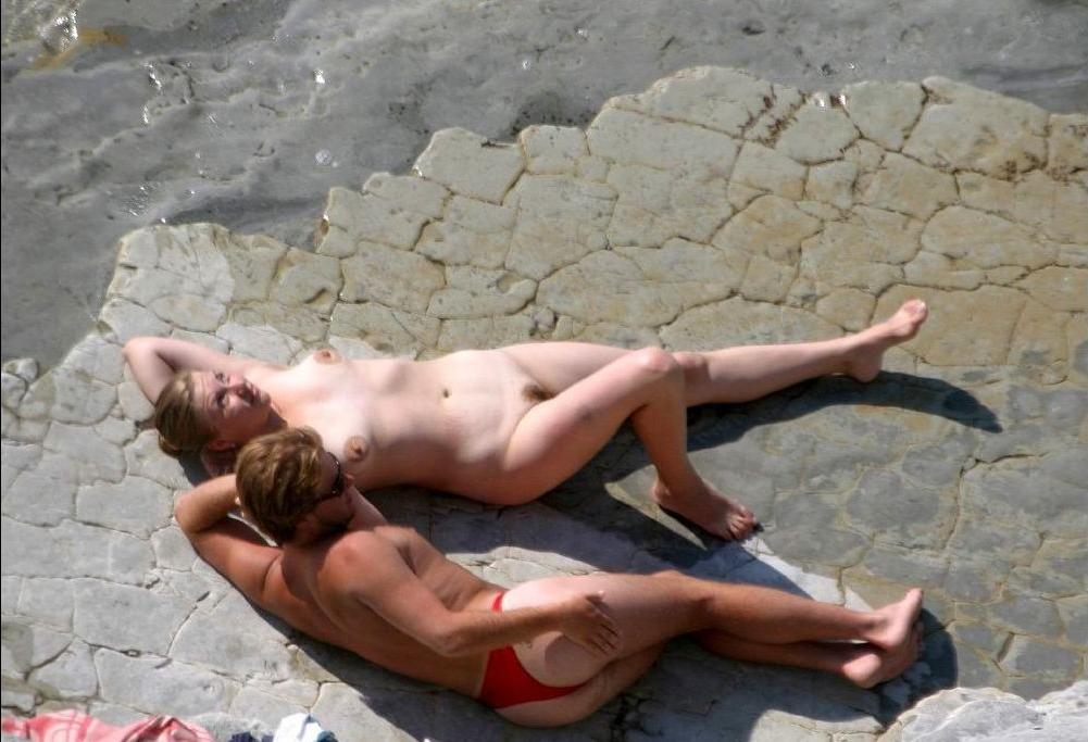 15P Watch this teen nudist rubbing sand on her body