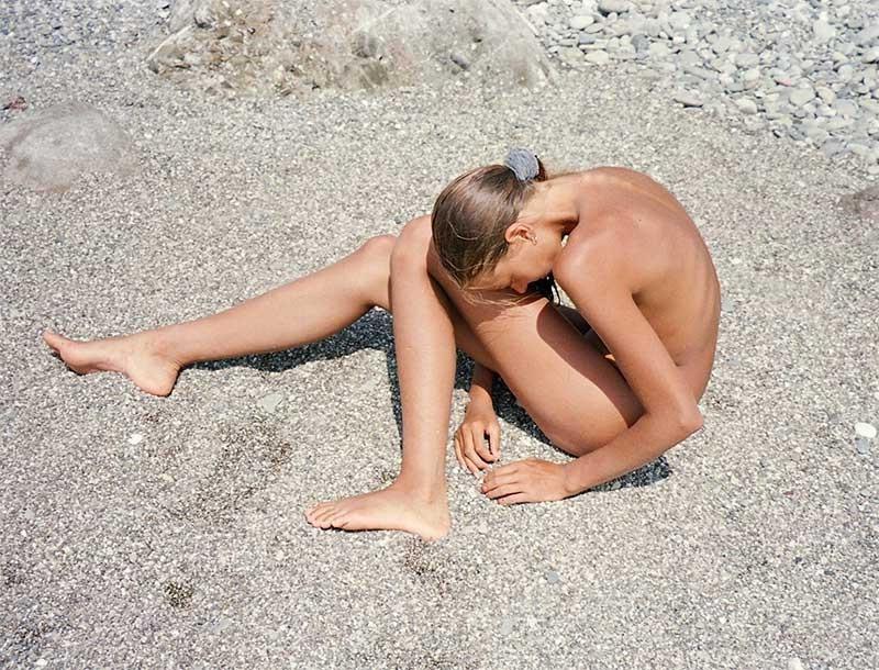 15P Watch this teen nudist rubbing sand on her body