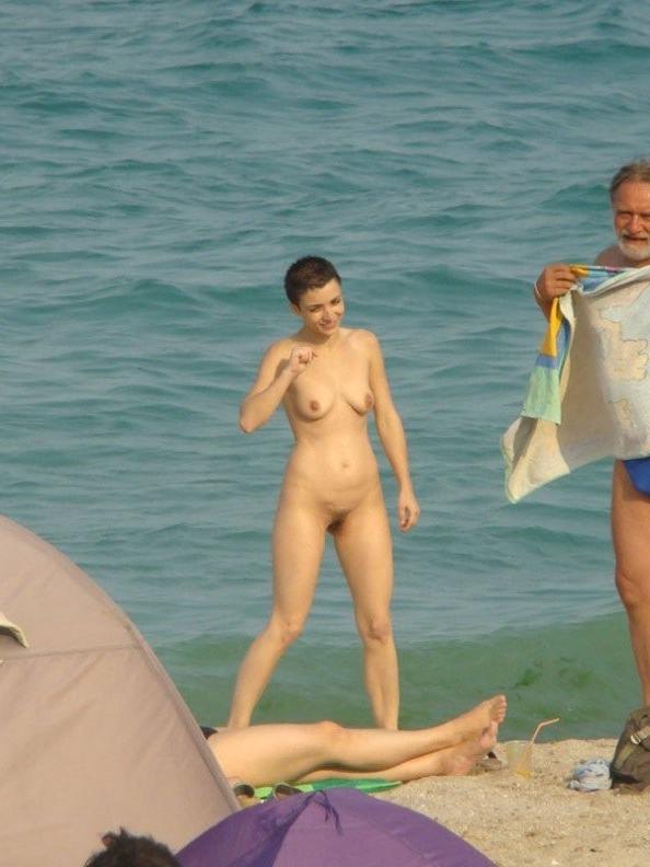 8P Two skinny nudist girls frolic around the beach