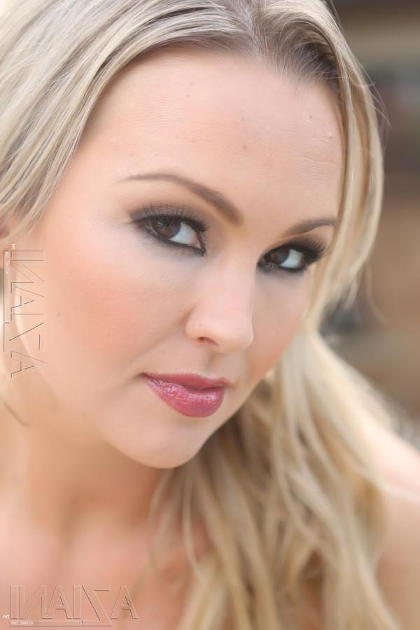 14P The beautiful blonde bombshell Abbey Brooks shows off her sexy curves while posi