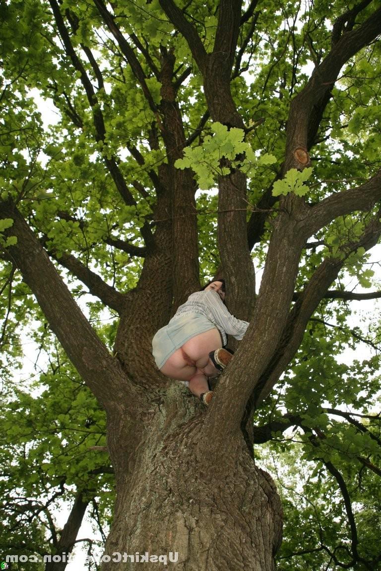 15P Doll in skirt climbs up the tree and has her cunt bared
