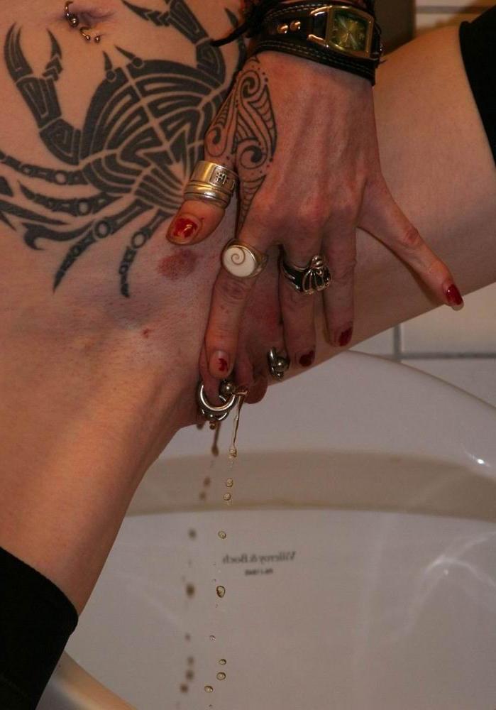 16P extreme pierced and tattoo babe pee in the toilet