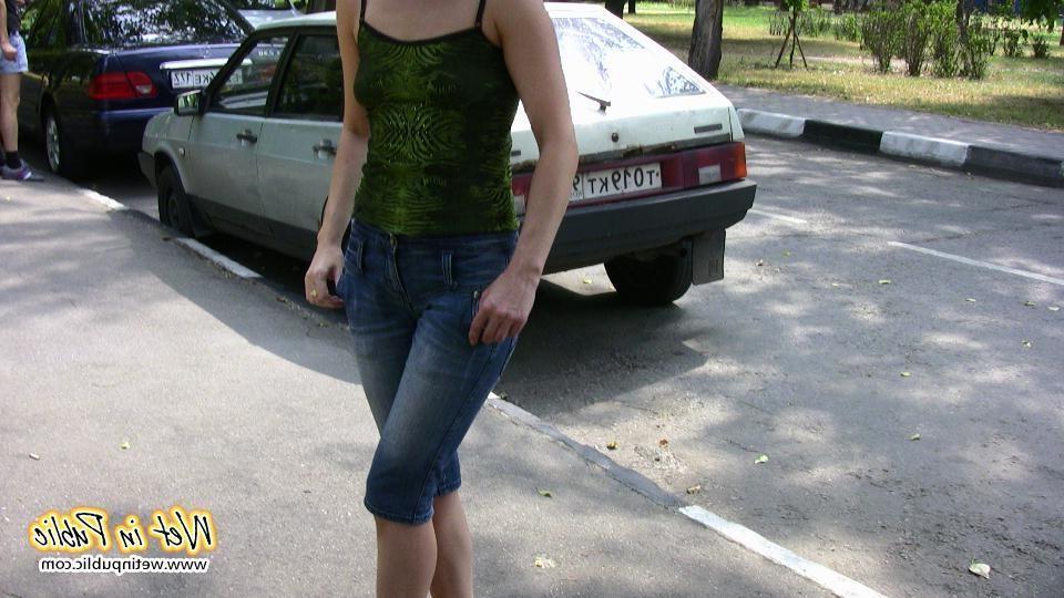 16P Attractive chick wets her jeans breeches and changes behind the bushes