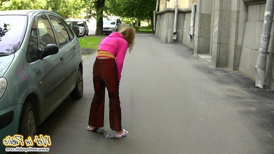 12P Nasty babe pee-soaks her sexy crimson pants behind a car in the yard