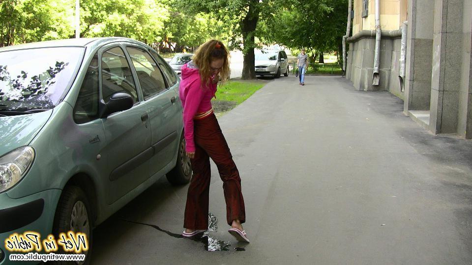 12P Nasty babe pee-soaks her sexy crimson pants behind a car in the yard