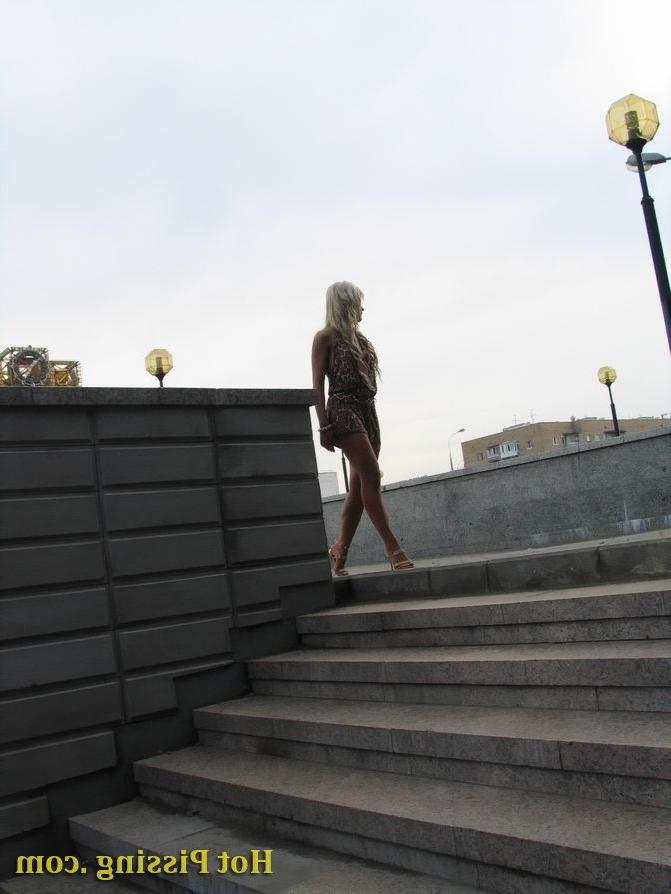 15P Beautiful amateur blonde takes a pee on the stairs