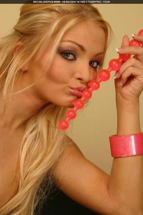 16P Blonde Nicky Angel playing with her toys on a couch