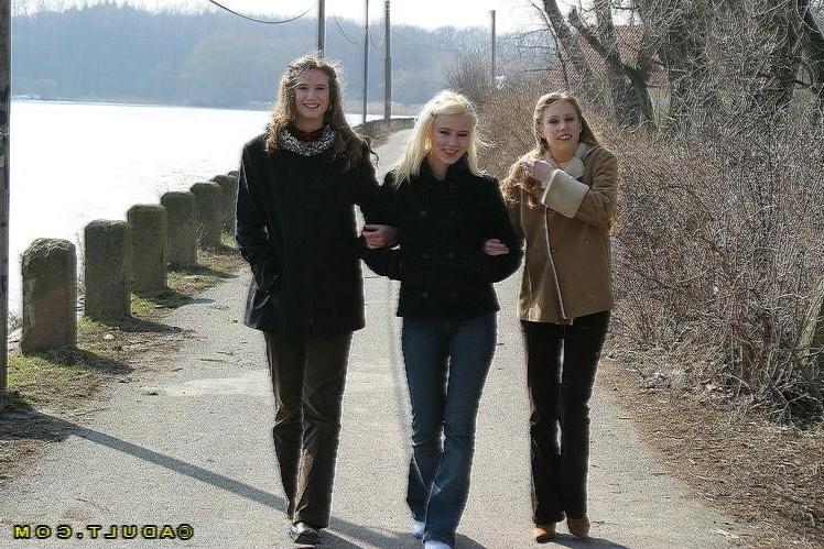 16P Three cute playful lesbians walking in the park