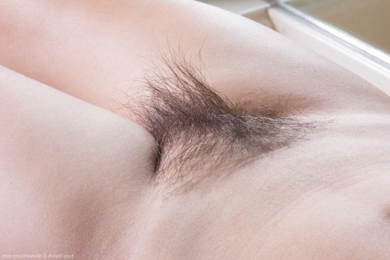 15P Sexy Lucy Dutch strips and combs her hairy pussy