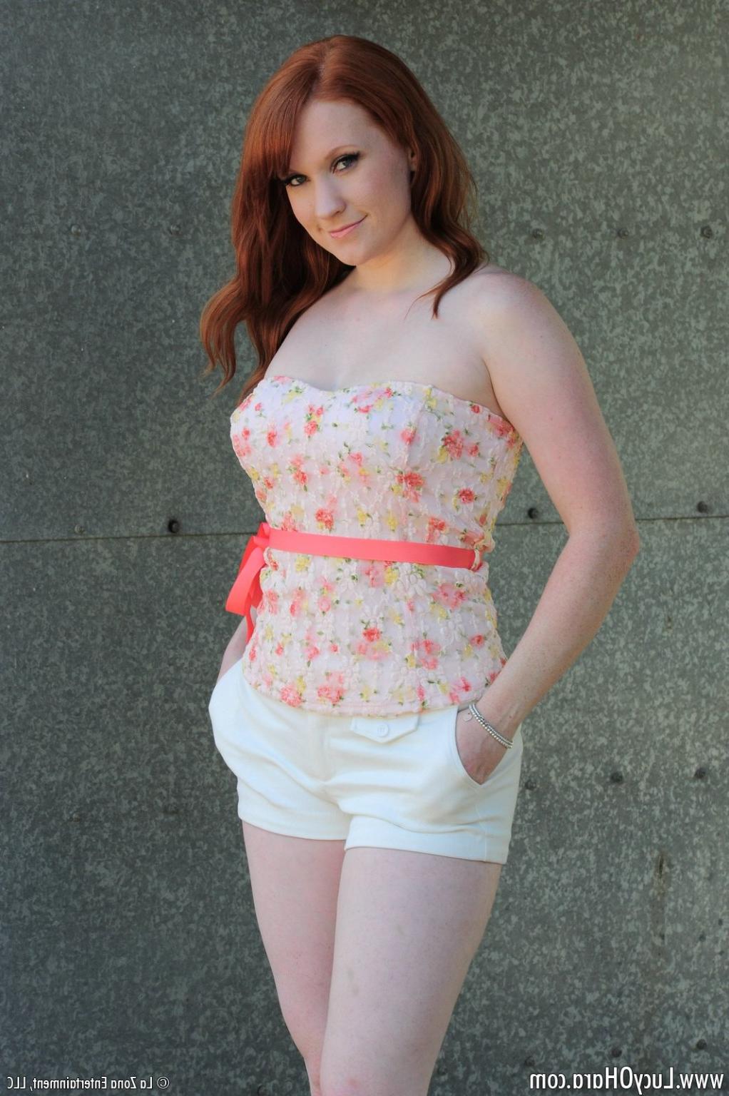 15P Busty redhead Lucy strips outside