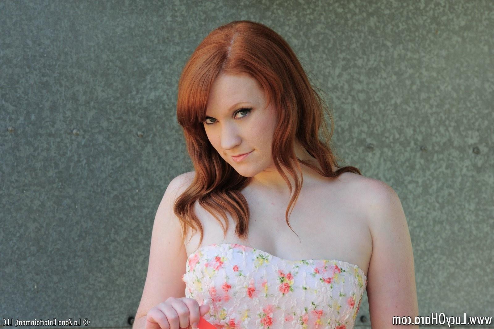 15P Busty redhead Lucy strips outside