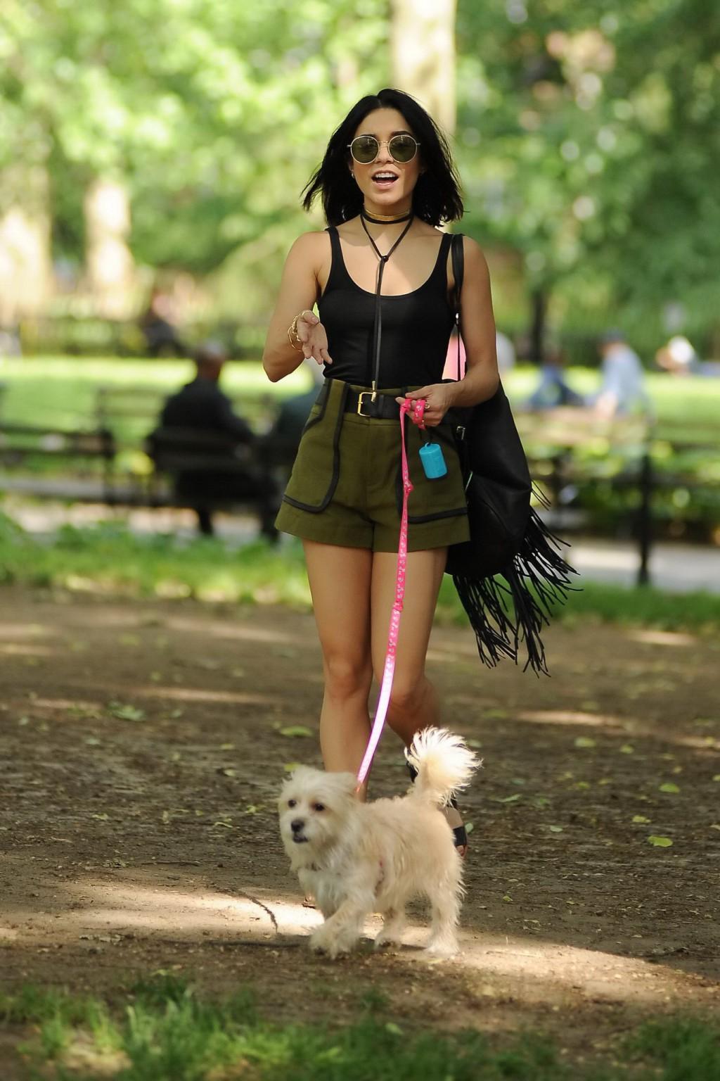 16P Vanessa Hudgens in a tiny black tank top and shorts takes her dog at a park in N