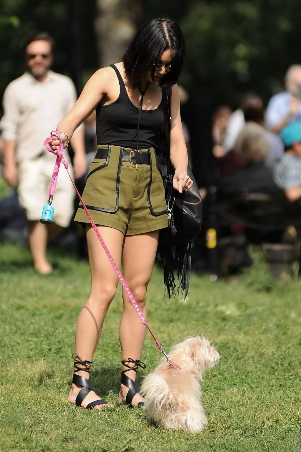 16P Vanessa Hudgens in a tiny black tank top and shorts takes her dog at a park in N