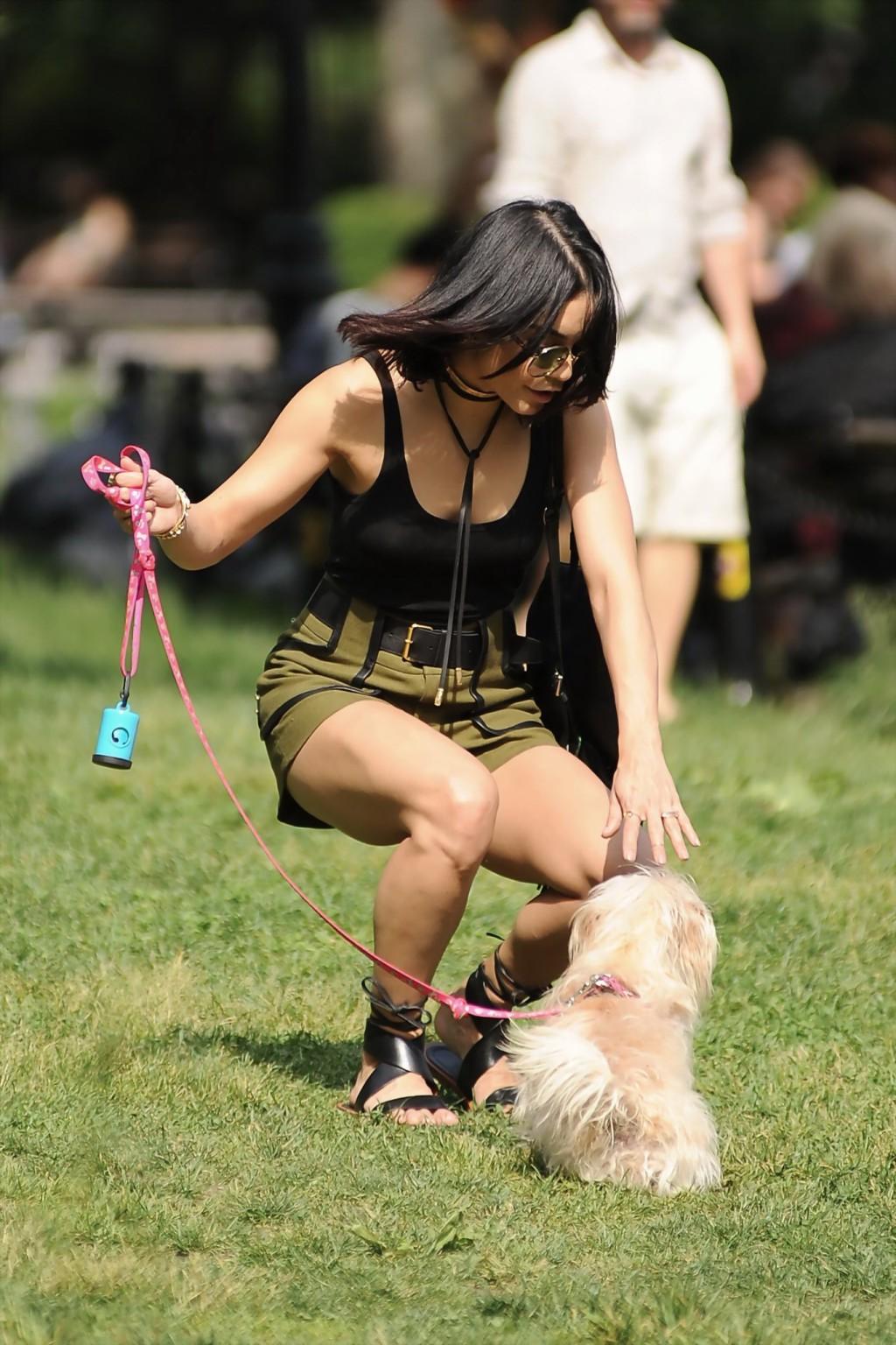 16P Vanessa Hudgens in a tiny black tank top and shorts takes her dog at a park in N