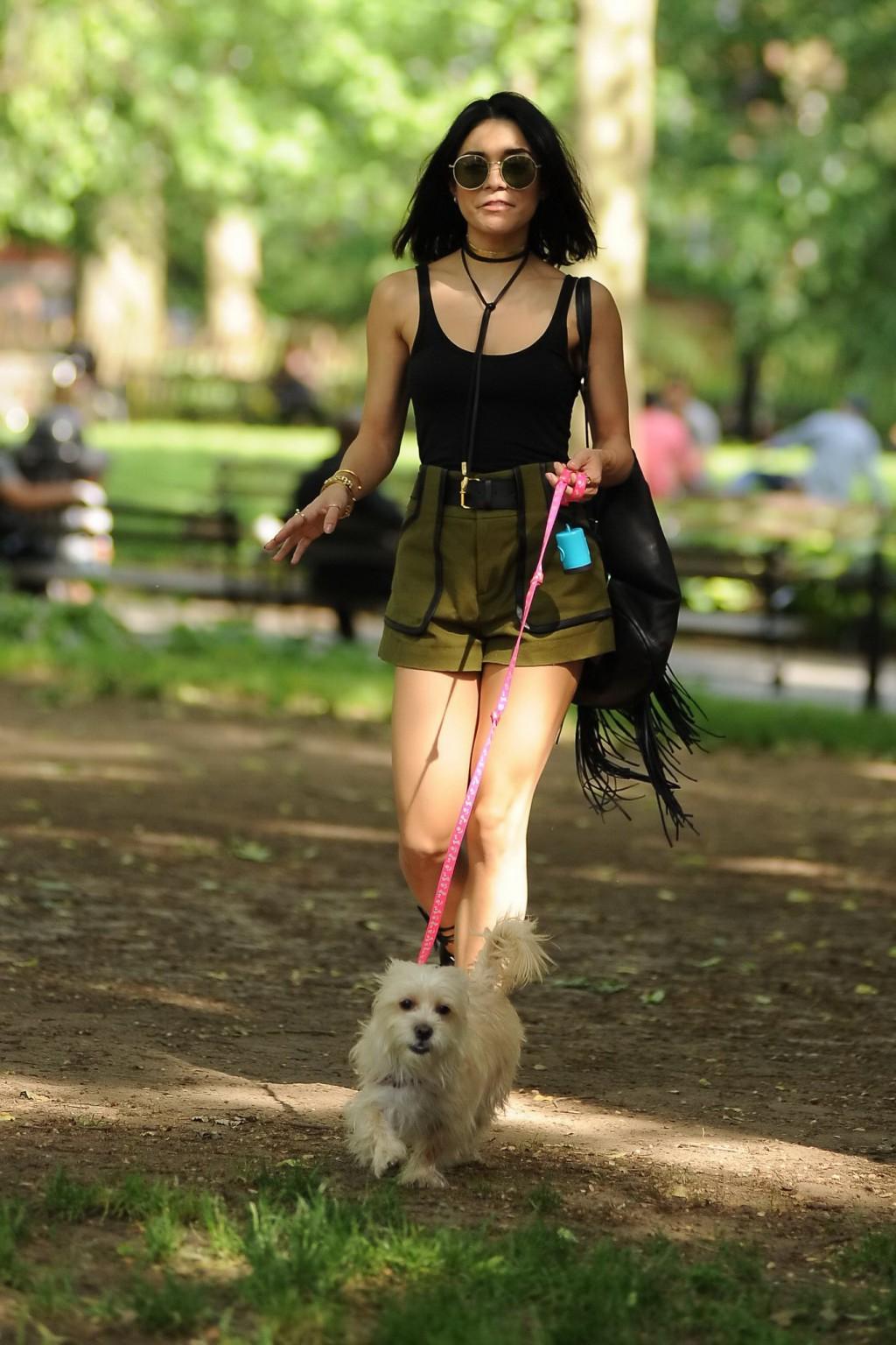 16P Vanessa Hudgens in a tiny black tank top and shorts takes her dog at a park in N