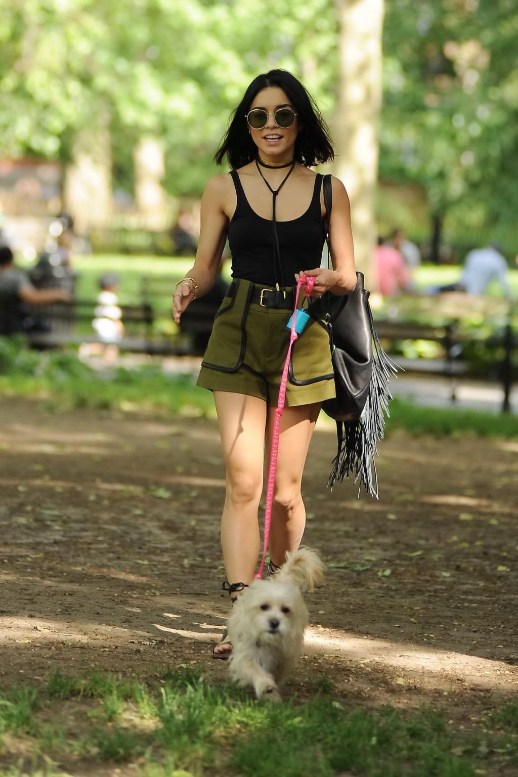 16P Vanessa Hudgens in a tiny black tank top and shorts takes her dog at a park in N