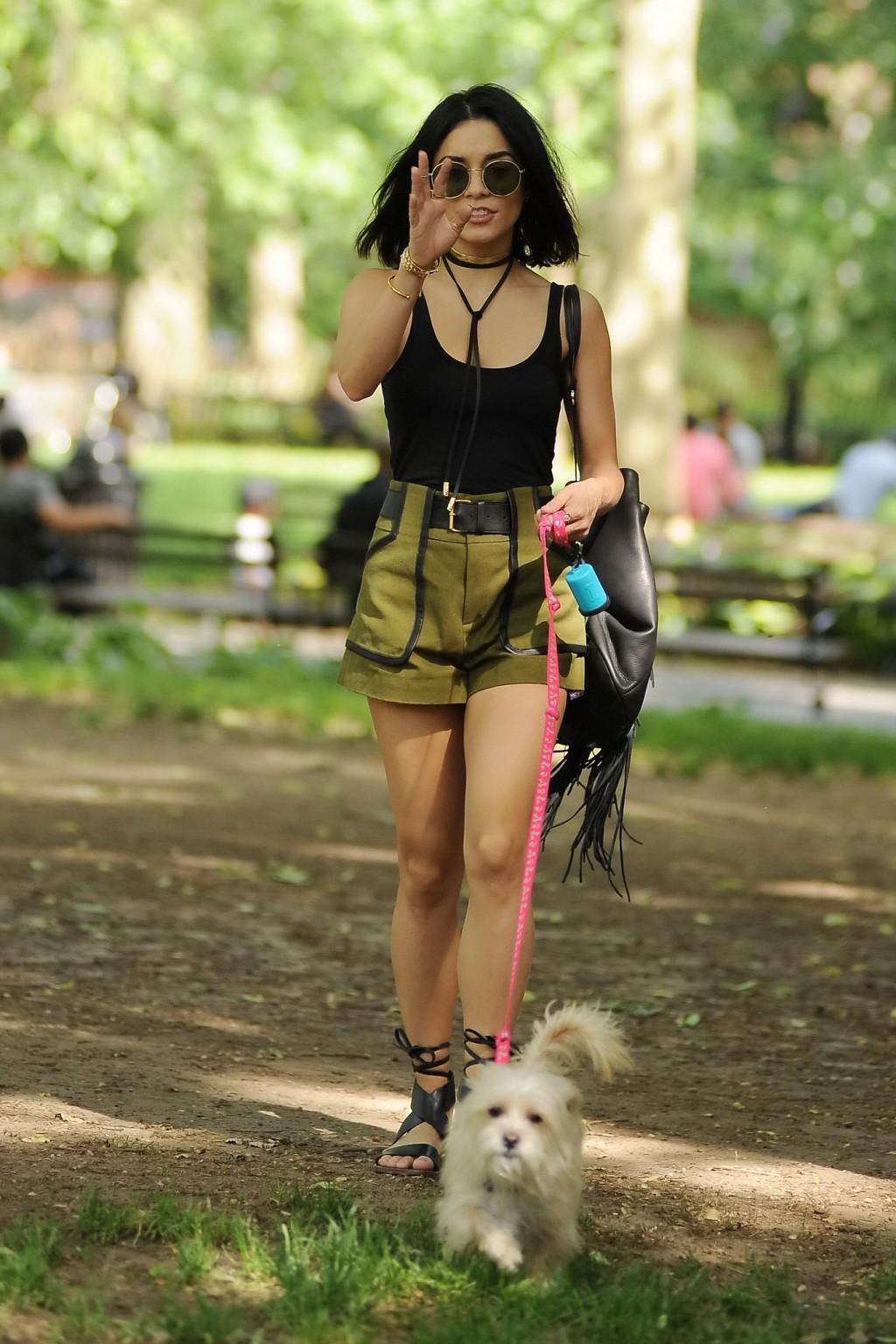 16P Vanessa Hudgens in a tiny black tank top and shorts takes her dog at a park in N