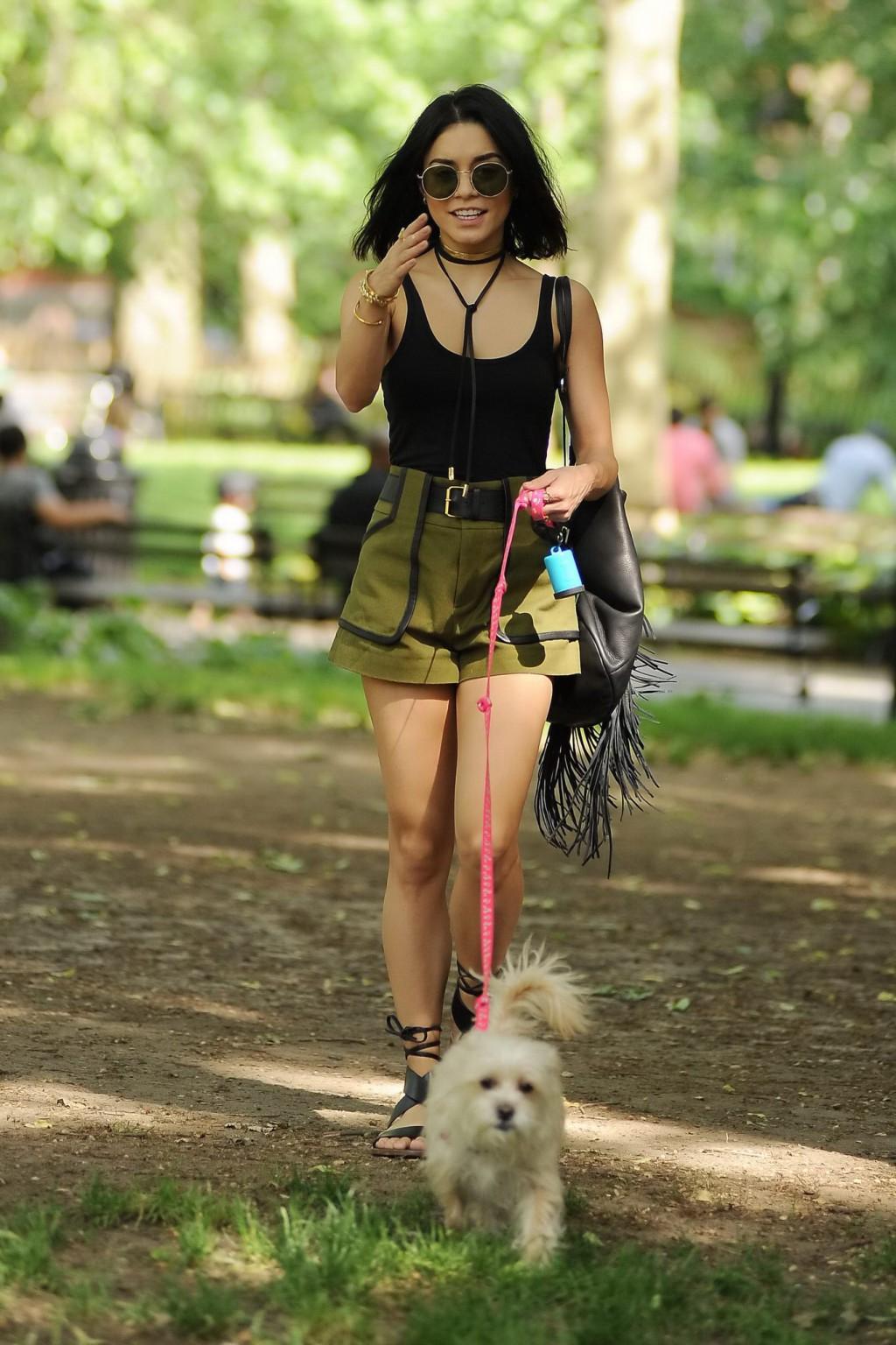 16P Vanessa Hudgens in a tiny black tank top and shorts takes her dog at a park in N