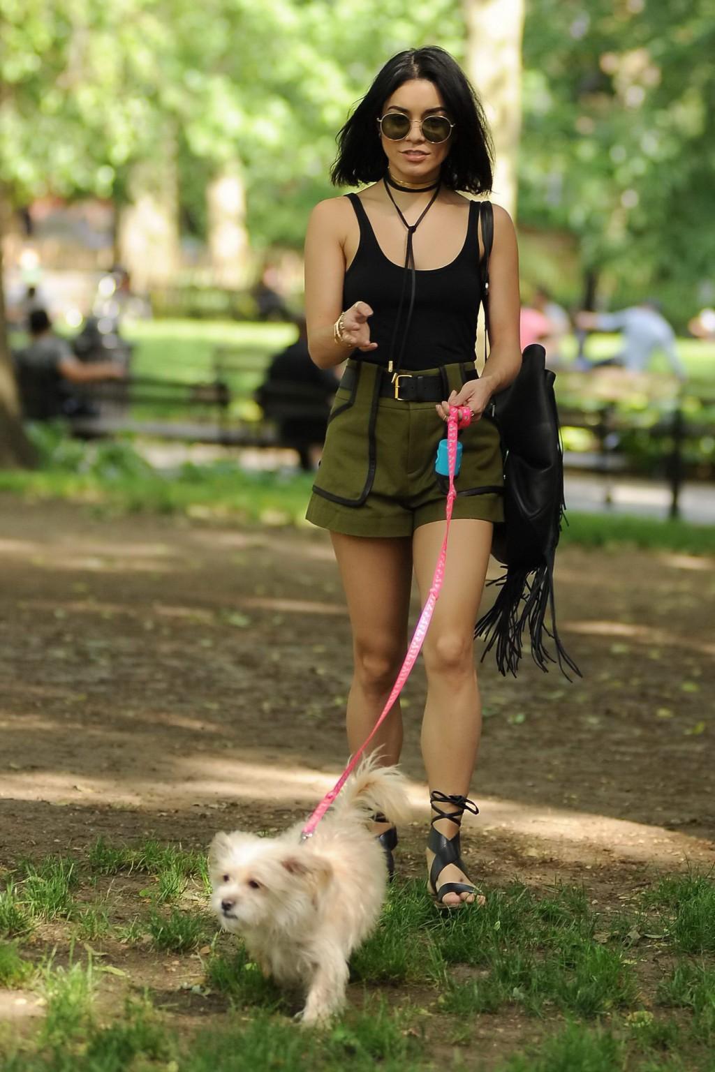 16P Vanessa Hudgens in a tiny black tank top and shorts takes her dog at a park in N