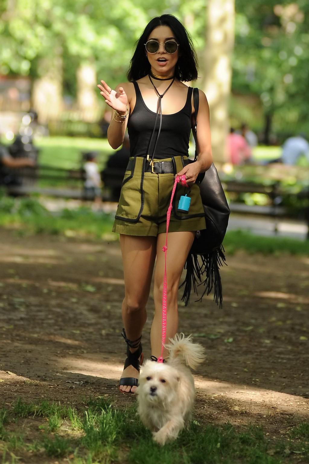 16P Vanessa Hudgens in a tiny black tank top and shorts takes her dog at a park in N