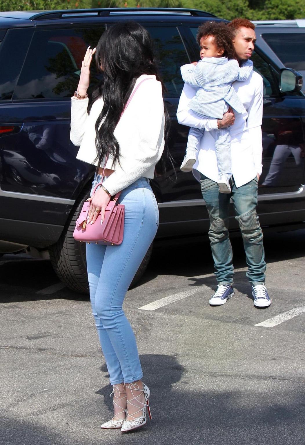 16P Kylie Jenner shows off her ass and cameltoe wearing tight jeans outside a church