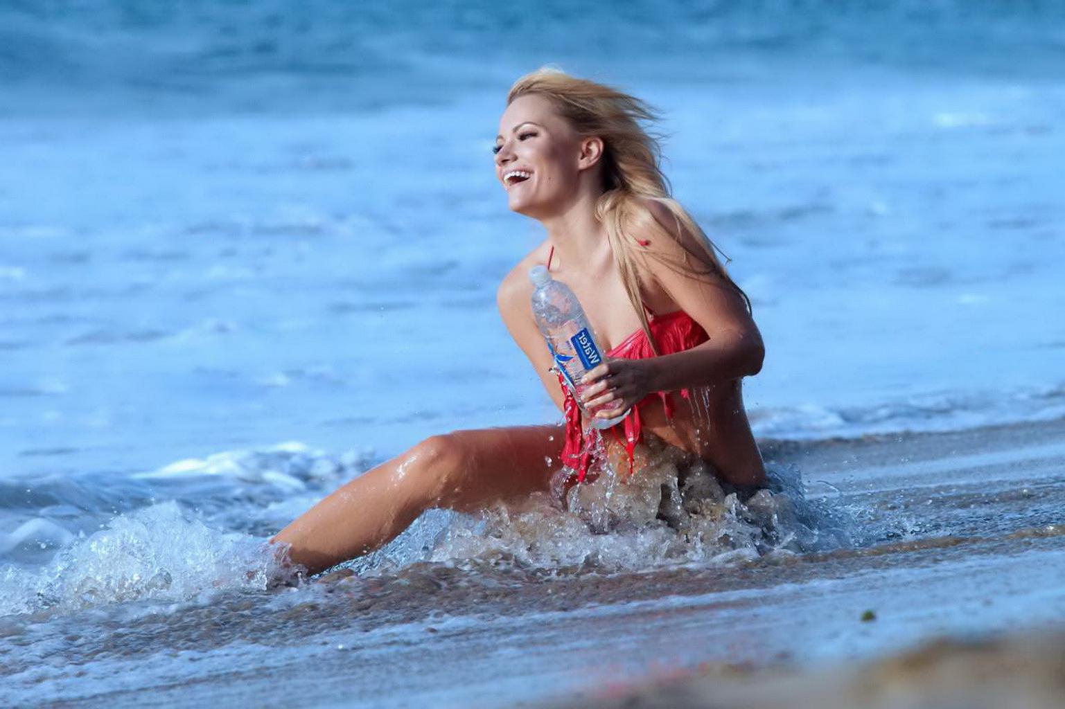 16P Caitlin OConnor busty showing cameltoe in a skimpy red bikini at the beach in Pa