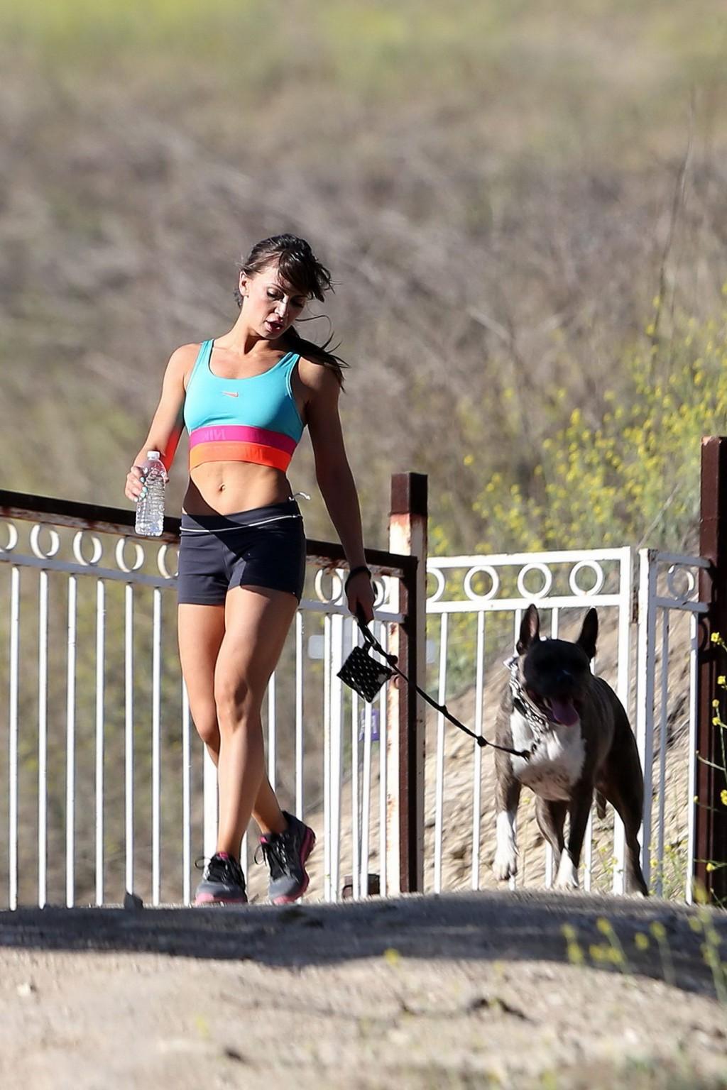 16P Karina Smirnoff in sports bra and shorts hiking with a dog at the park in LA