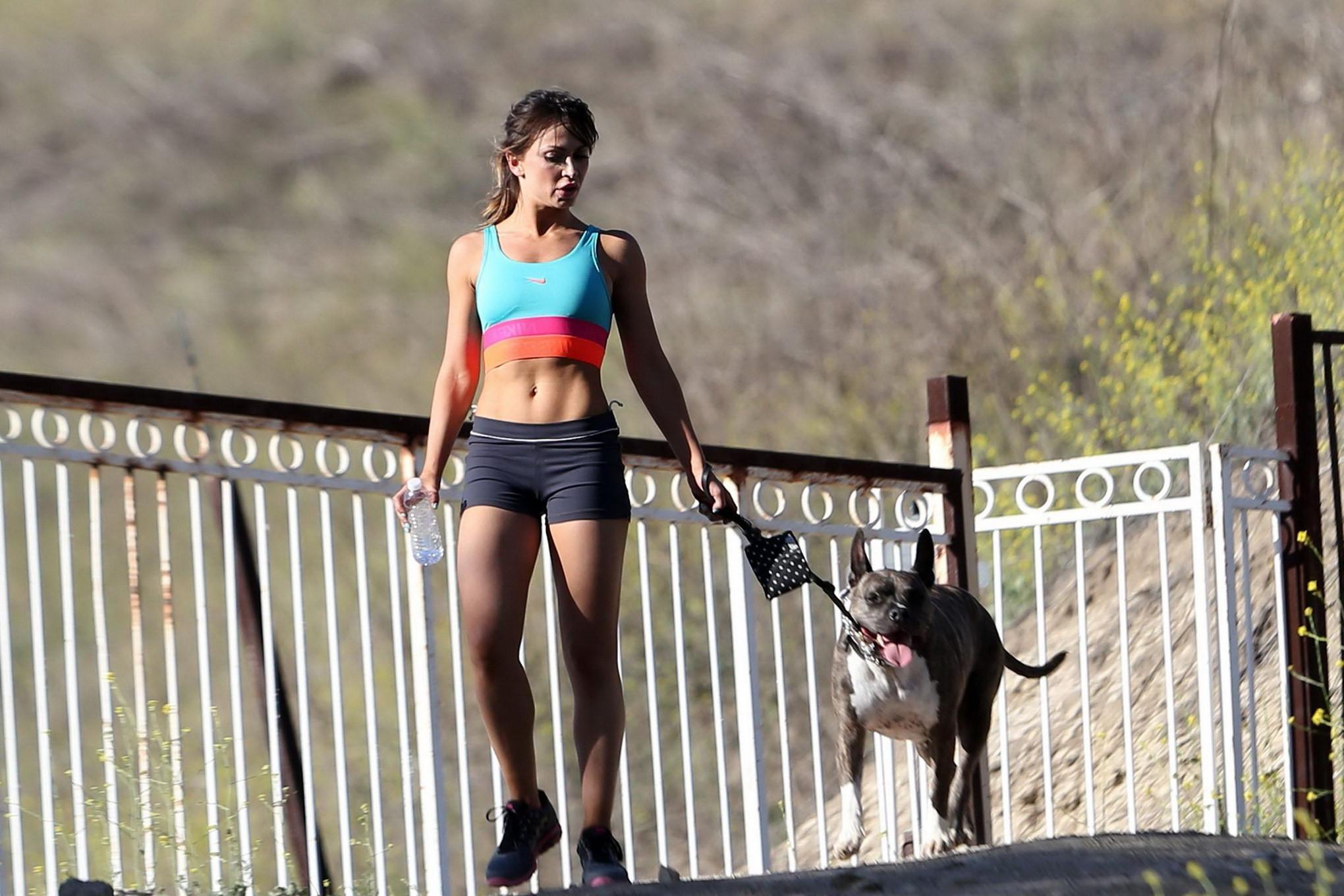 16P Karina Smirnoff in sports bra and shorts hiking with a dog at the park in LA