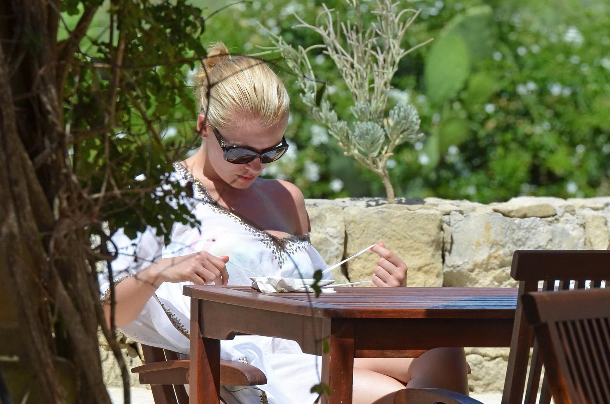 10P Katherine Jenkins in black bikini  tanning topless on a holiday in Malta