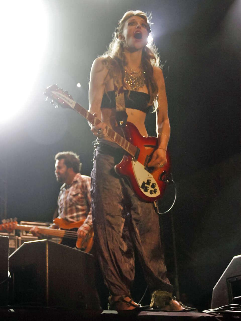 16P Courtney Love stripping down to topless and show tits on stage