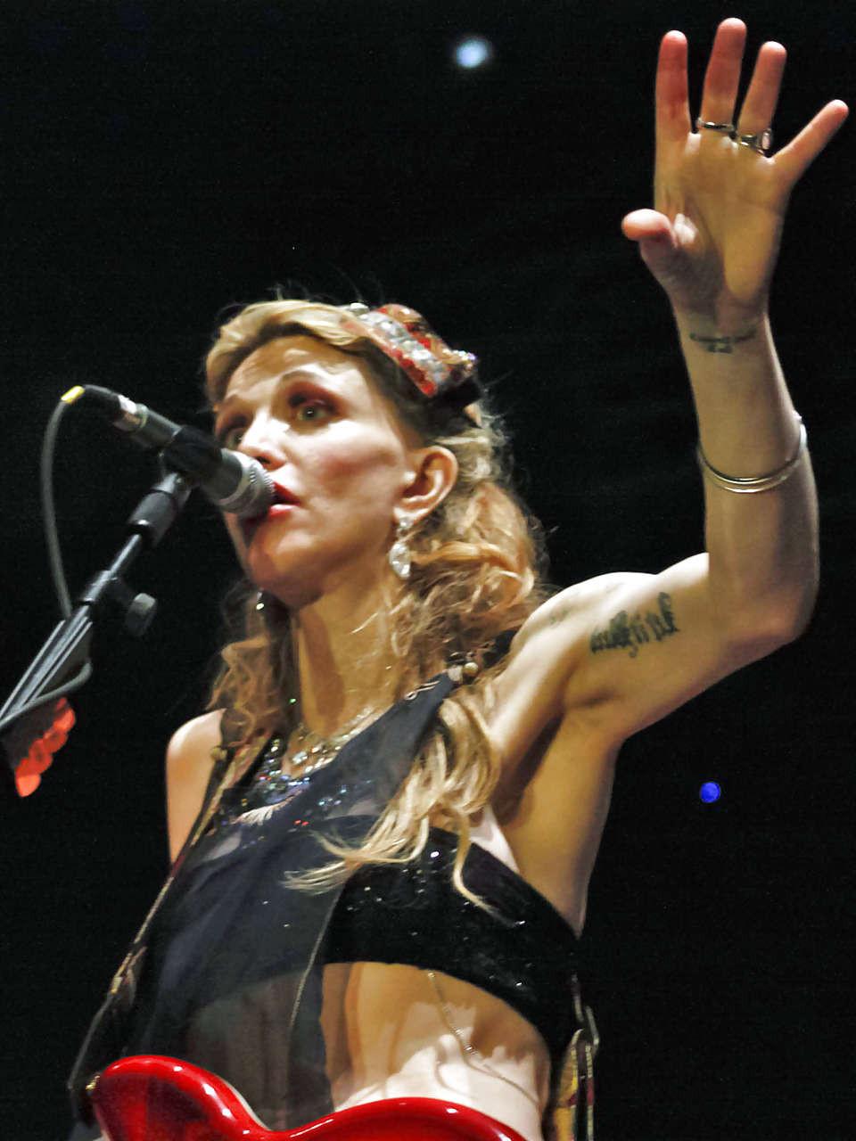 16P Courtney Love stripping down to topless and show tits on stage