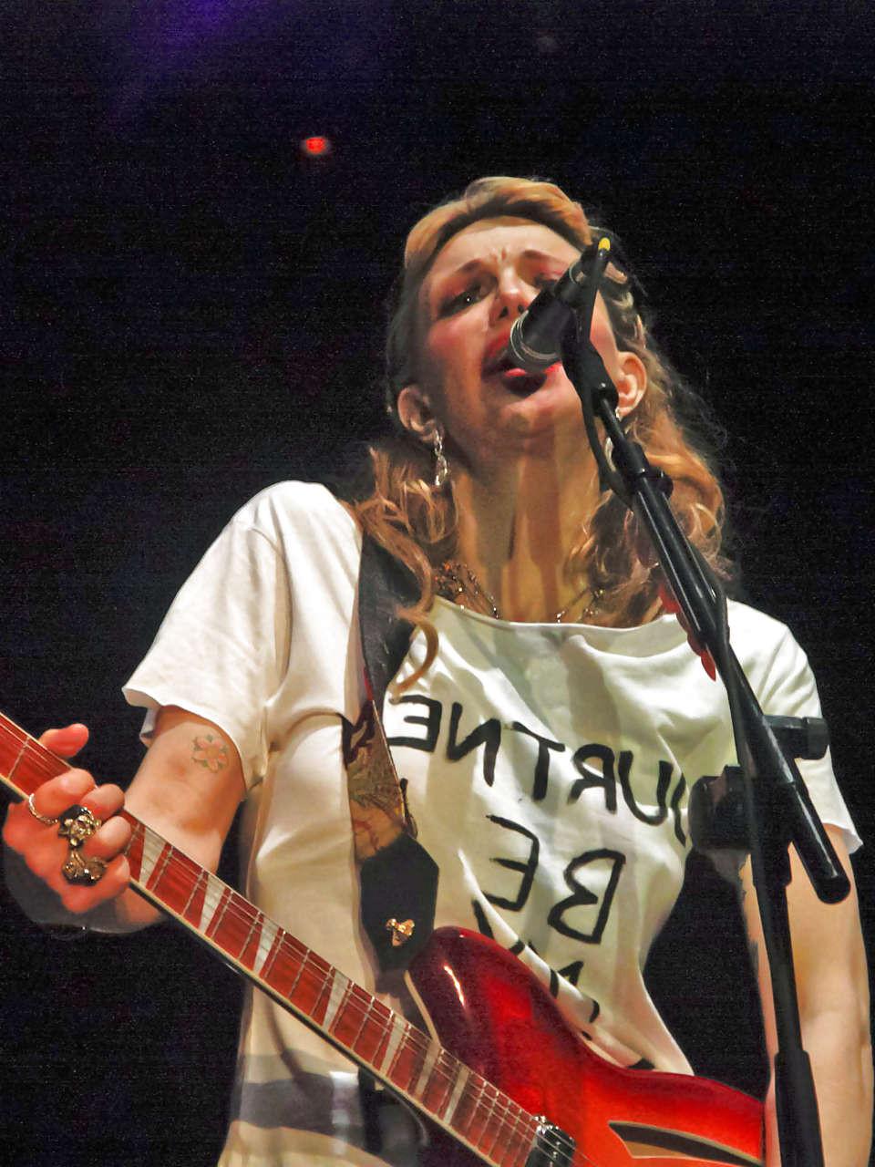 16P Courtney Love stripping down to topless and show tits on stage