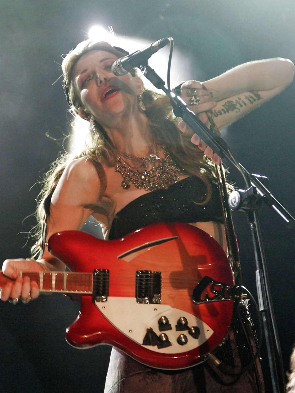 16P Courtney Love stripping down to topless and show tits on stage