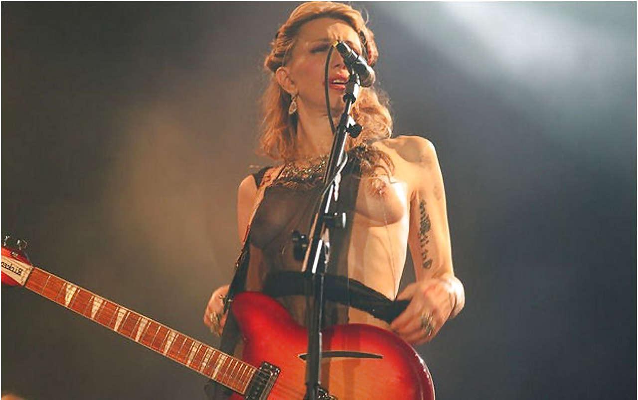 16P Courtney Love stripping down to topless and show tits on stage