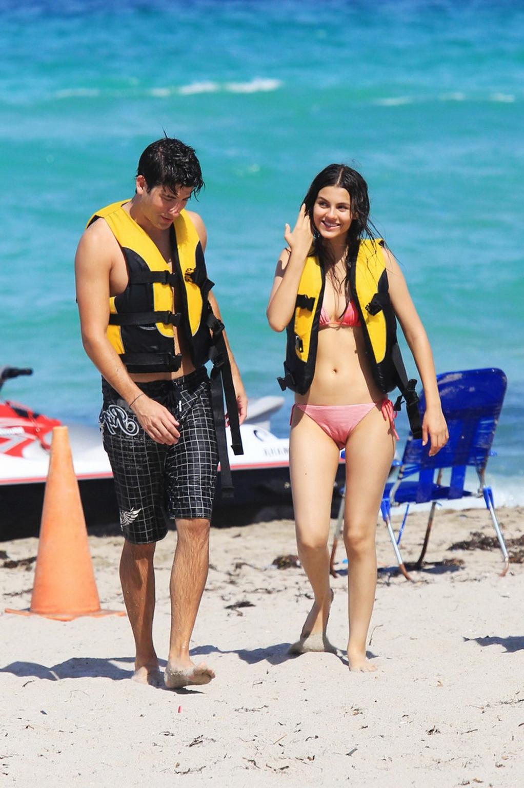 16P Victoria Justice shows cameltoe wearing wet bikini on a beach in Florida