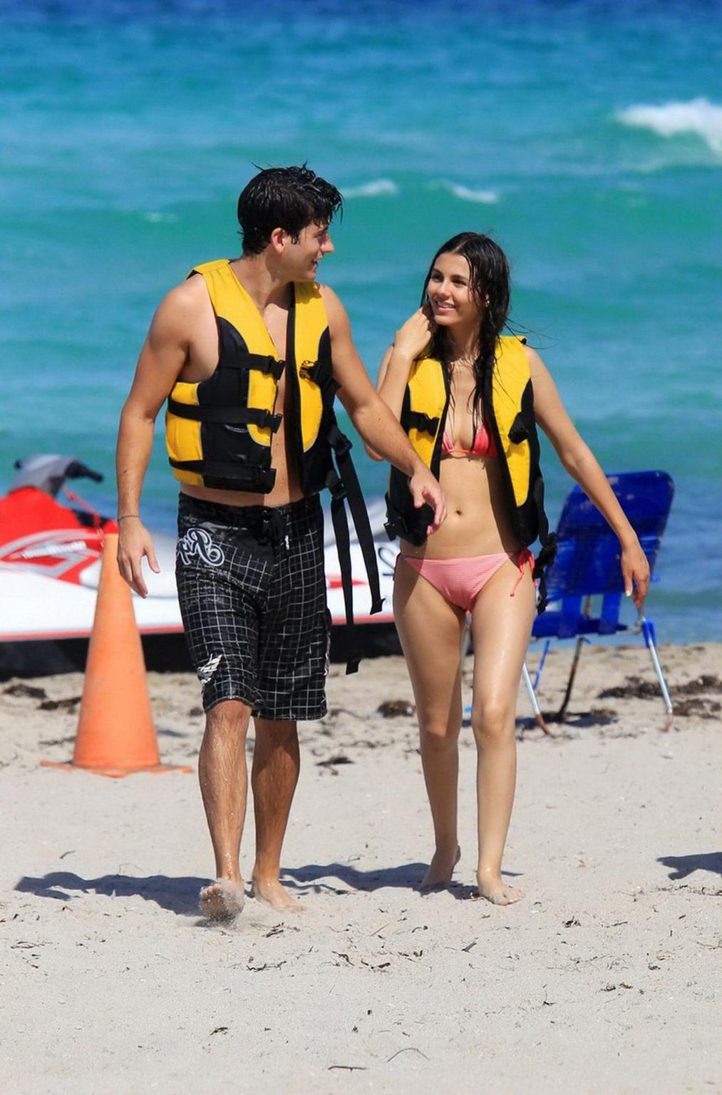 16P Victoria Justice shows cameltoe wearing wet bikini on a beach in Florida