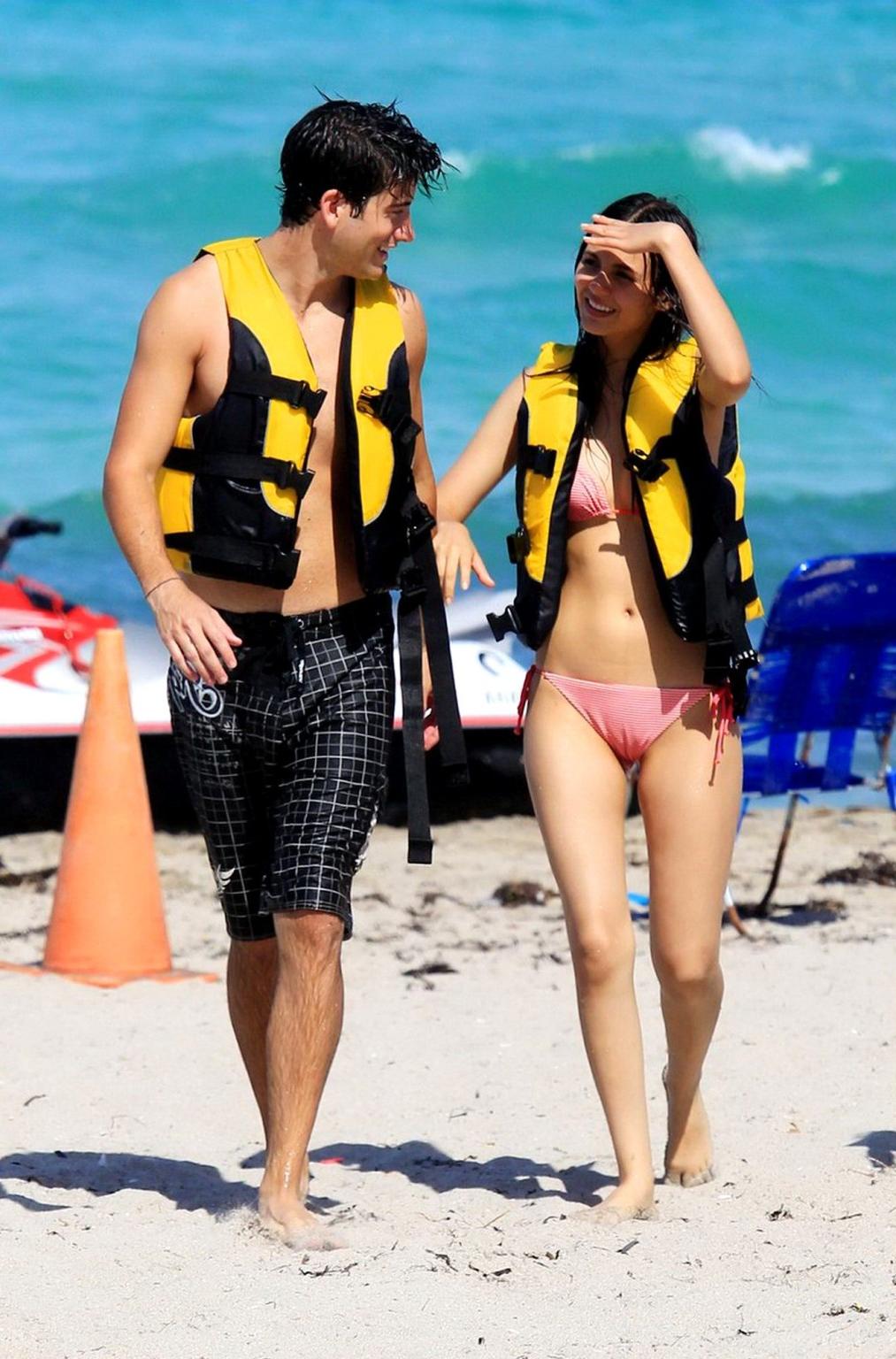 16P Victoria Justice shows cameltoe wearing wet bikini on a beach in Florida