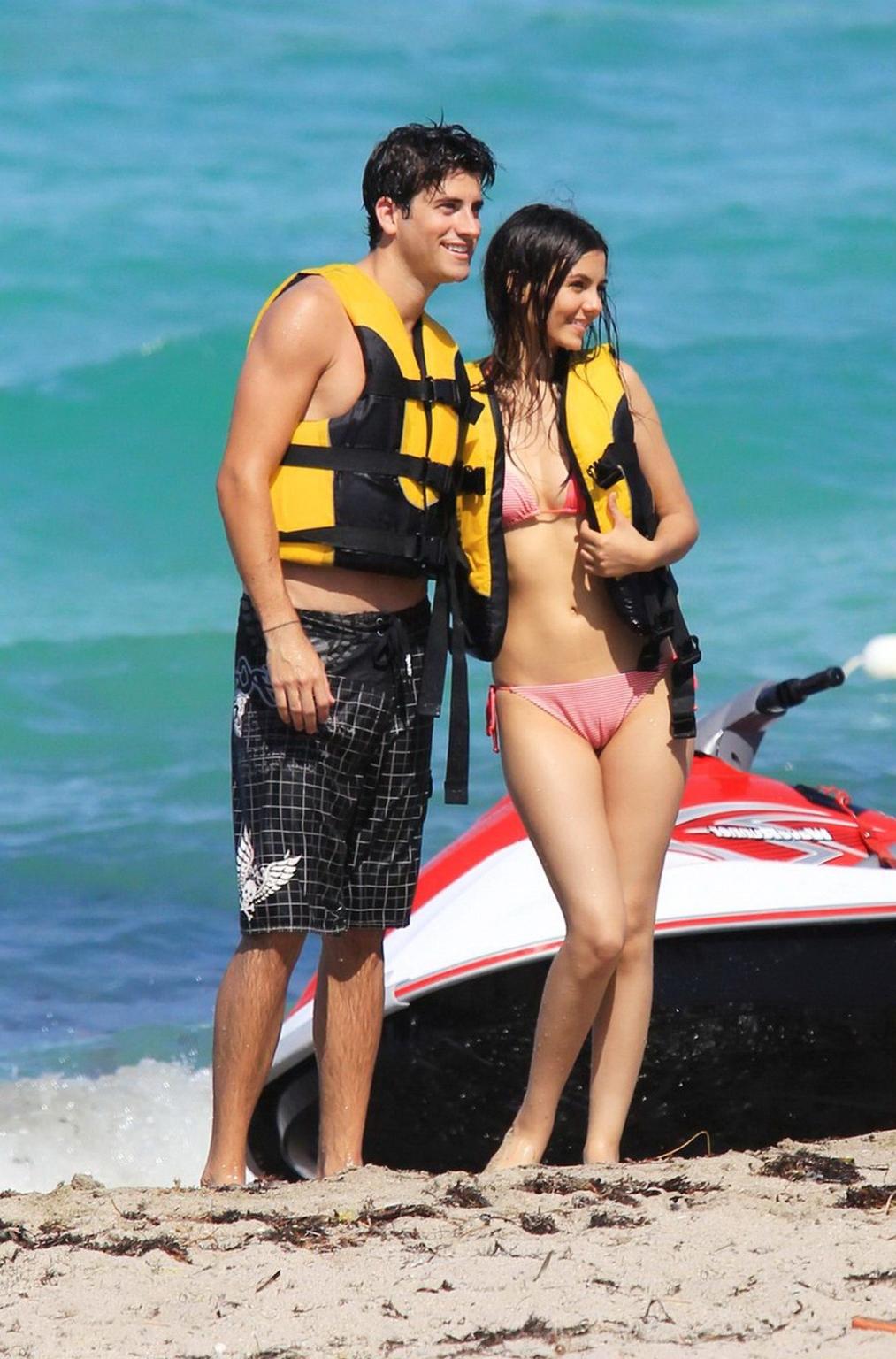 16P Victoria Justice shows cameltoe wearing wet bikini on a beach in Florida
