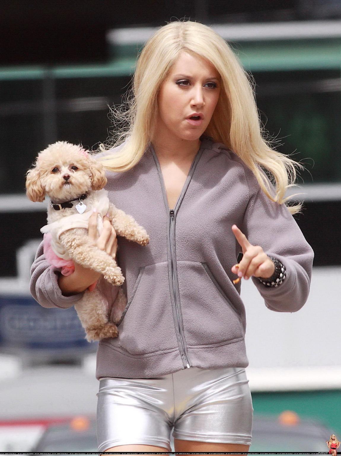 16P Ashley Tisdale showing cameltoe in tight silver shorts on the set